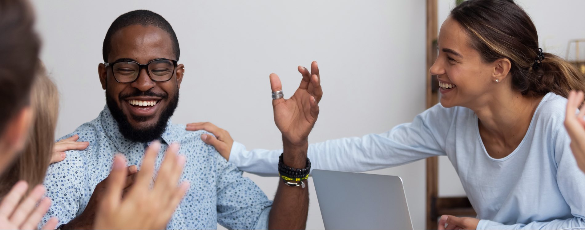 woman congratulating male work colleague