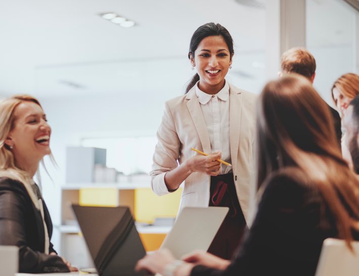 commercial team of women meeting and laughing