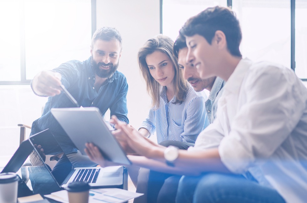 team studying tablet to make utility decision