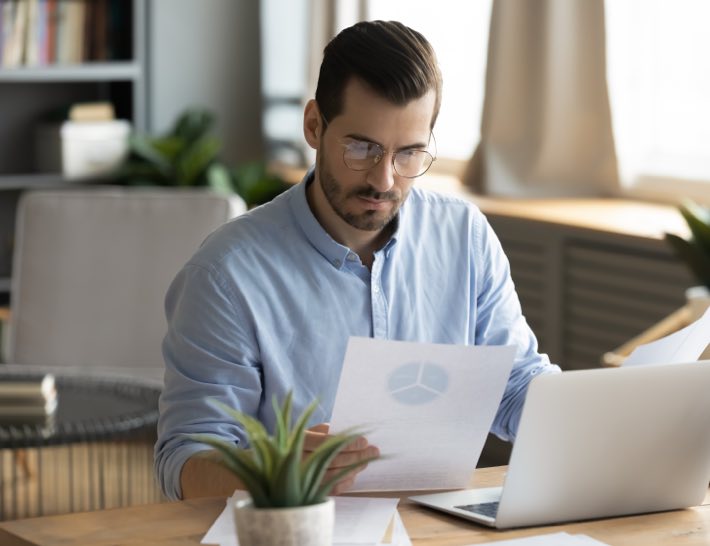 man studying data analytics for utilities sheet