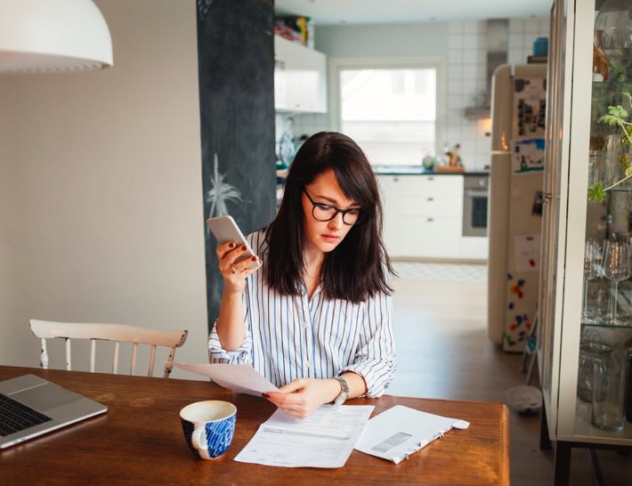 woman looking at utility bill for utility expense management