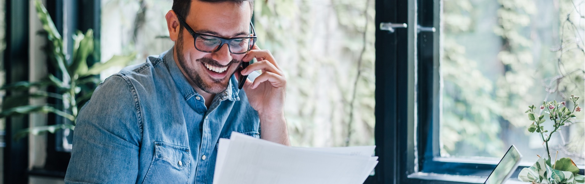 man smiling on phone discussing utility expense recovery