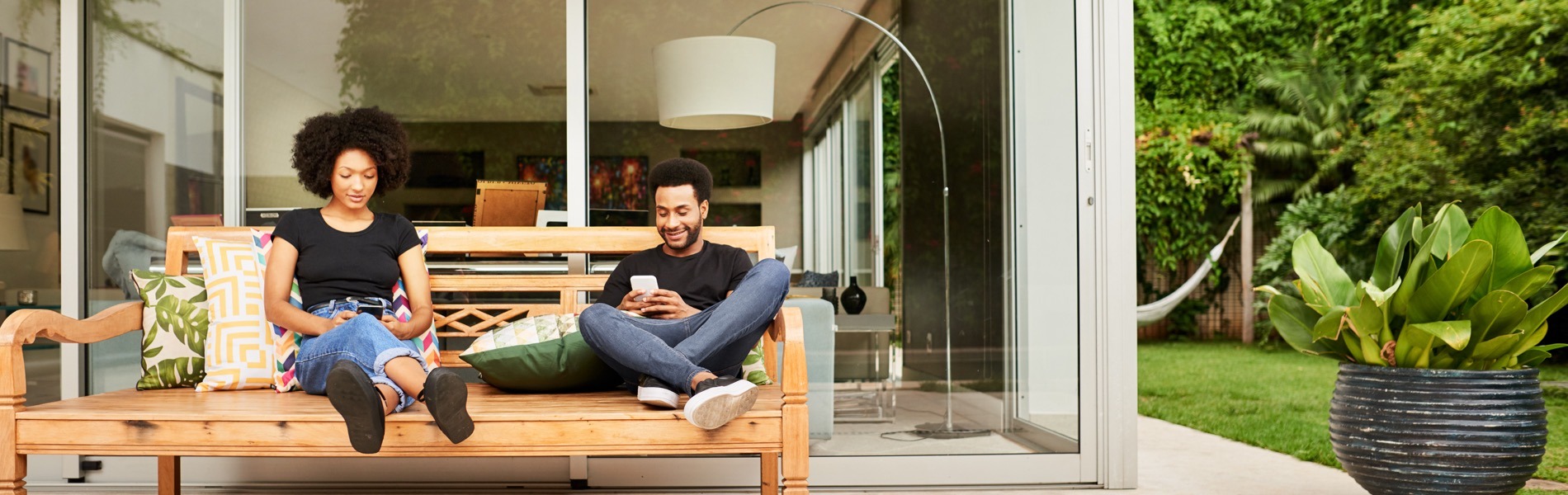 couple relaxing outside single family house