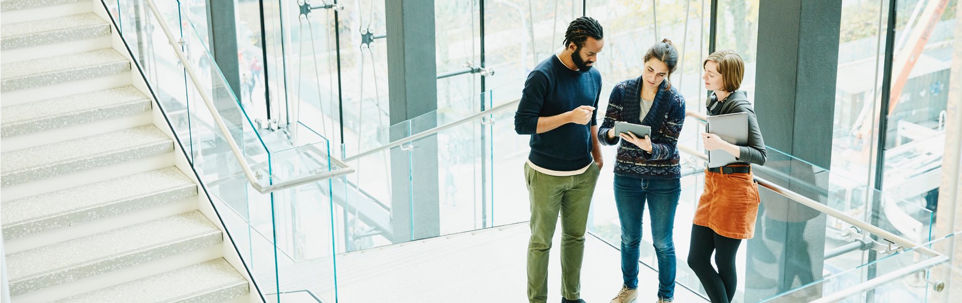 3 students looking at tablet